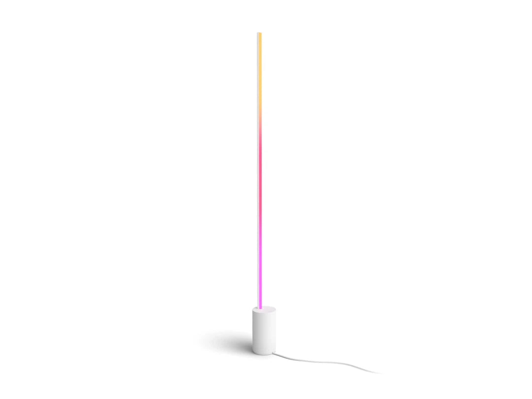 Philips HUE Signe gradient gulvlampe med en slank design i hvid farve og en farverig lysstribe der går fra gul til pink