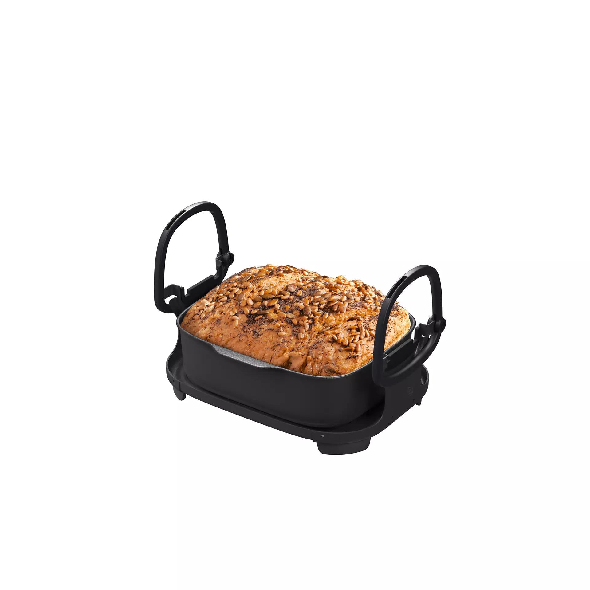 Philips NX0990/90 Gryde Air Steam Cooker med en bagt brødform fyldt med nødder og frø i en sort bageform med håndtag