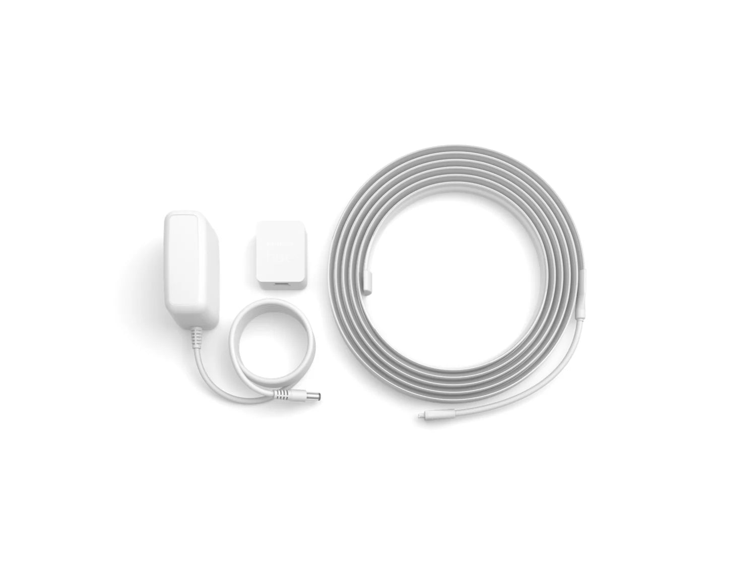 Philips HUE Solo lysstrip på 3 meter med en strømforsyning, en kontrolenhed og en sort ledning, alt i hvidt design.