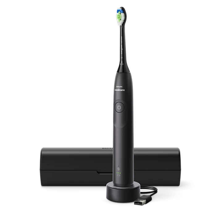 Philips Sonicare 5300 genopladelig tandbørste HX7101/02 med en grå sort finish og en børstehovede i grøn og blå farve ligger ved siden af et sort opladeretui med USB-opladning.