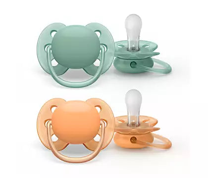 To pacifiers in different colors from Philips Avent the top pacifier is soft mint green and the bottom pacifier is soft peach suitable for babies aged zero to six months
