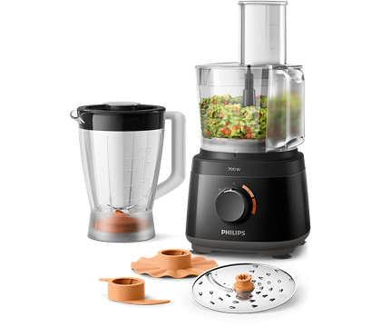 Kompakt Philips HR7320/10 foodprocessor med 700 W effekt præsenteret med skålen fyldt med hakkede grøntsager en blender og tilbehør såsom skiver og et rivejern i sort design perfekt til forskellige madlavningsopgaver