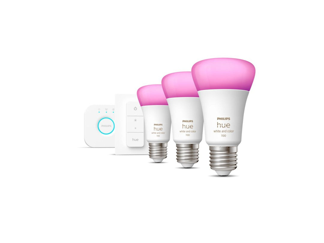 Philips Hue white color ambiance startsæt med tre lyskilder i E27 fatning en bridge og en switch på hvid baggrund lyskilderne viser en pink farvet lysdæmper