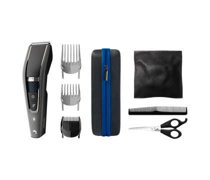 Philips HC7650/15 vaskbar hårklipper med Trim-n-Flow PRO-teknologi sammen med medfølgende tilbehør som kamme, saks og opbevaringsetui