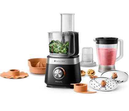 Philips HR7530/10 Kompakt foodprocessor i sort og sølv med 850W motor og 31 funktioner, inkluderer en skål med grøntsager, en blenderkanne med lyserød smoothie, samt forskellige tilbehørsdele som citruspresser og skiver til madlavning