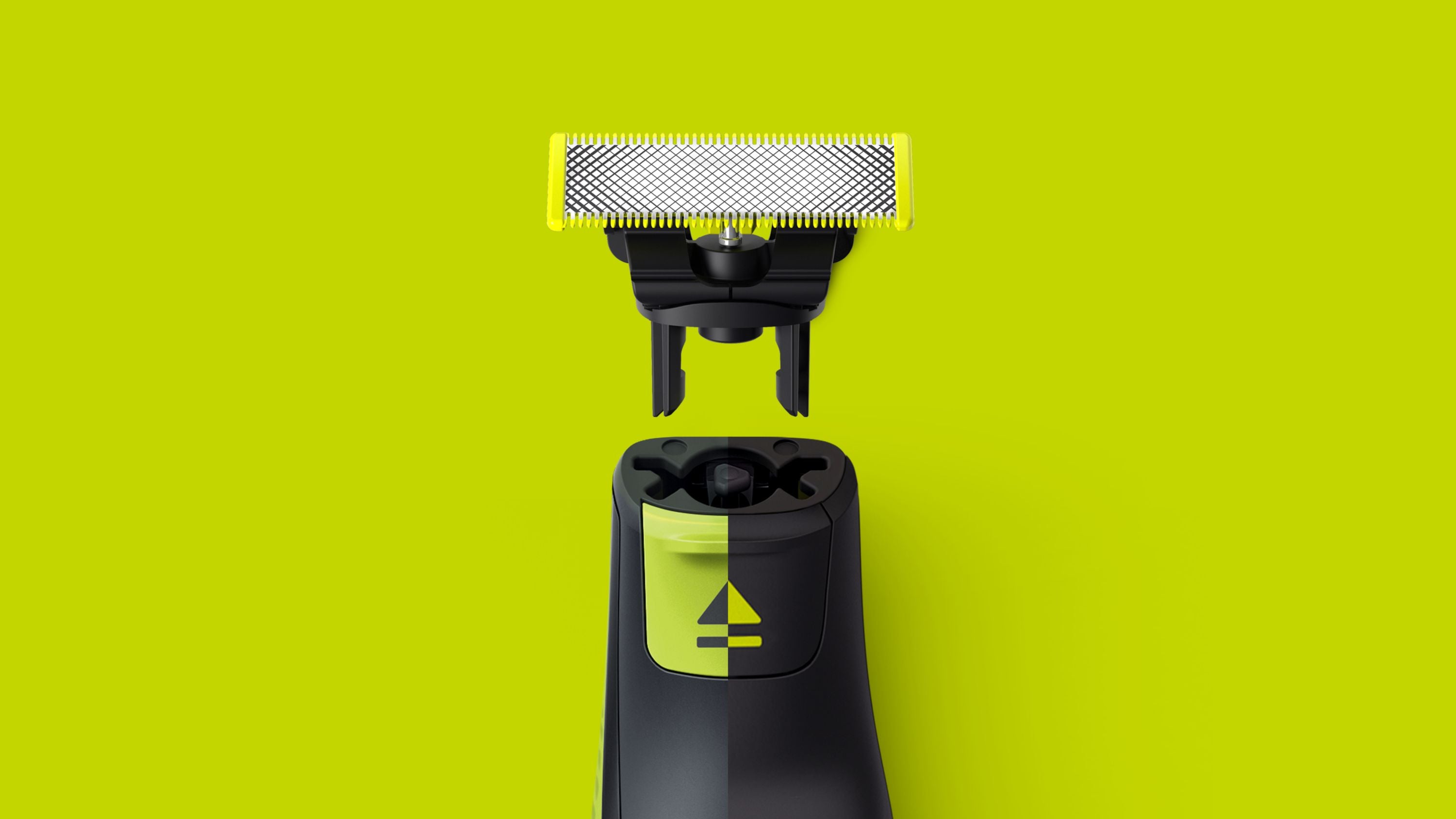 Billede af Philips OneBlade 360 udskiftningsskær til ansigt og krop med en tæt grøn baggrund som viser skæret synliggjort ovenfor selve enheden, der har en tydelig kontrolknap med et ikon.